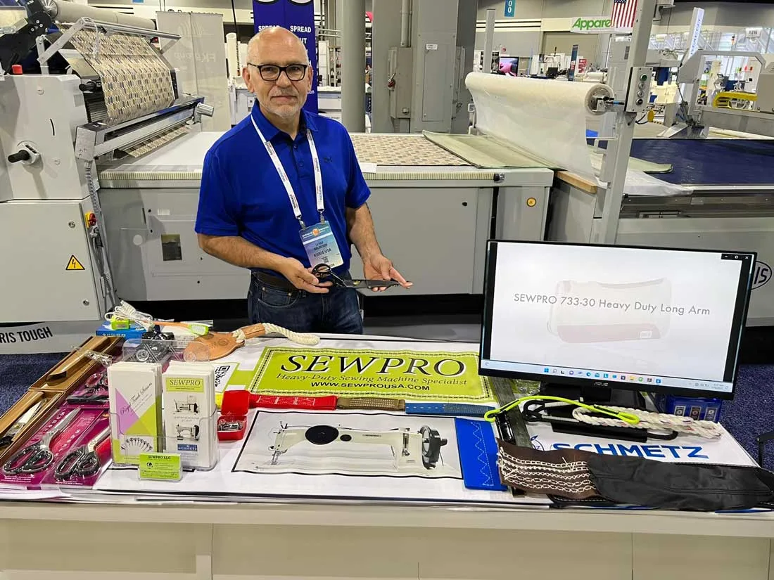 Sergey at the SEWPRO booth at a sewn products trade show