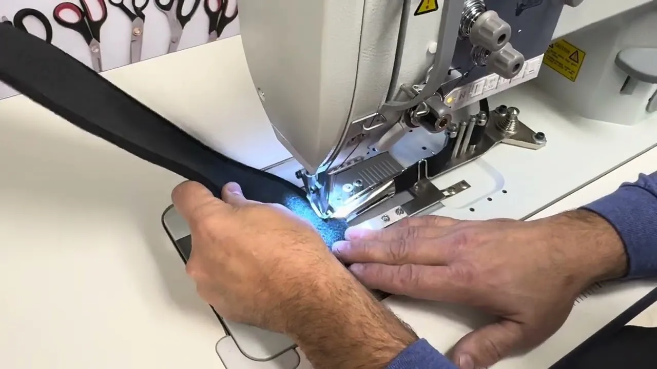 A walking foot feeding black webbing on a SEWPRO 867