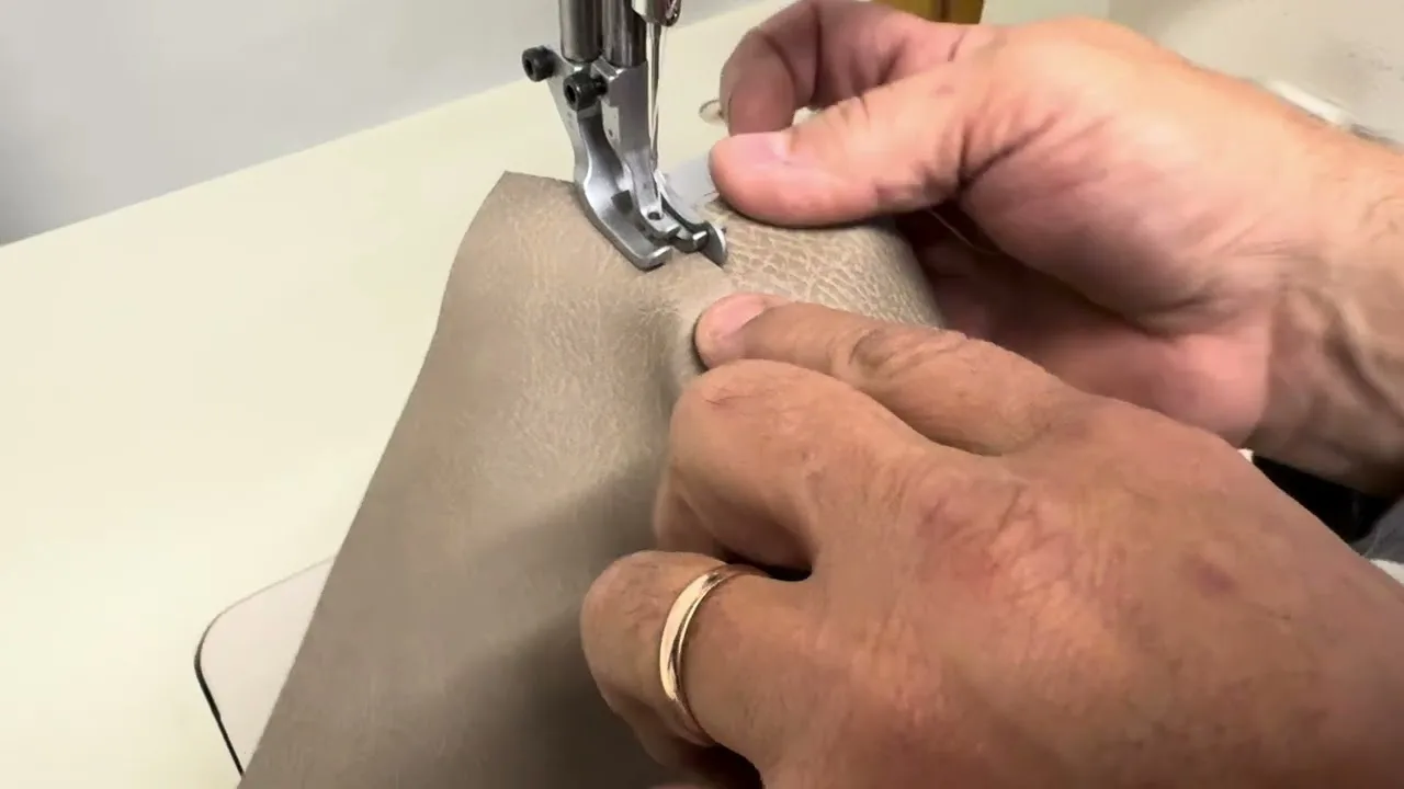 Leather being topstitched under the foot of a SEWPRO machine