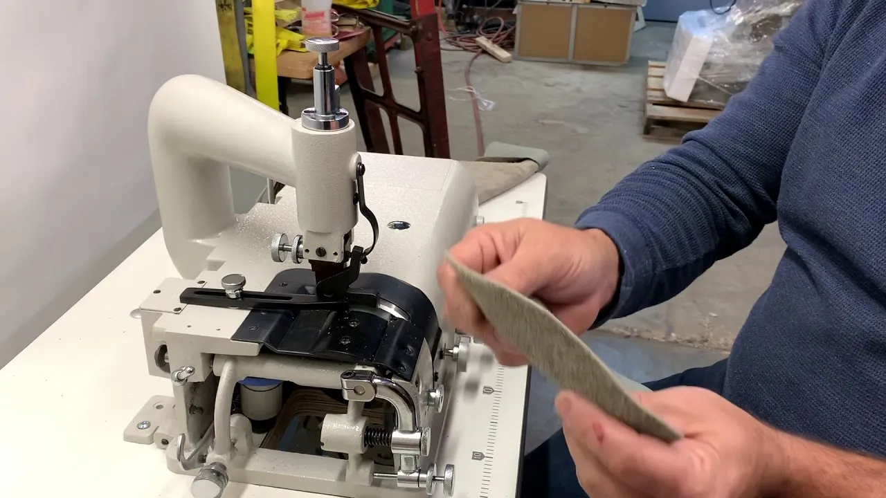 Sergey holding a skived leather piece at a SEWPRO 801 bell knife skiver