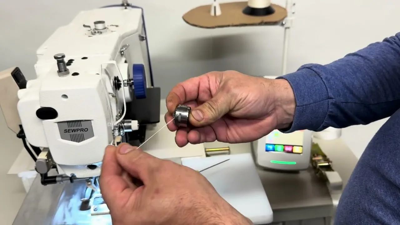 A tie-down strap clamped in a SEWPRO programmable pattern sewer